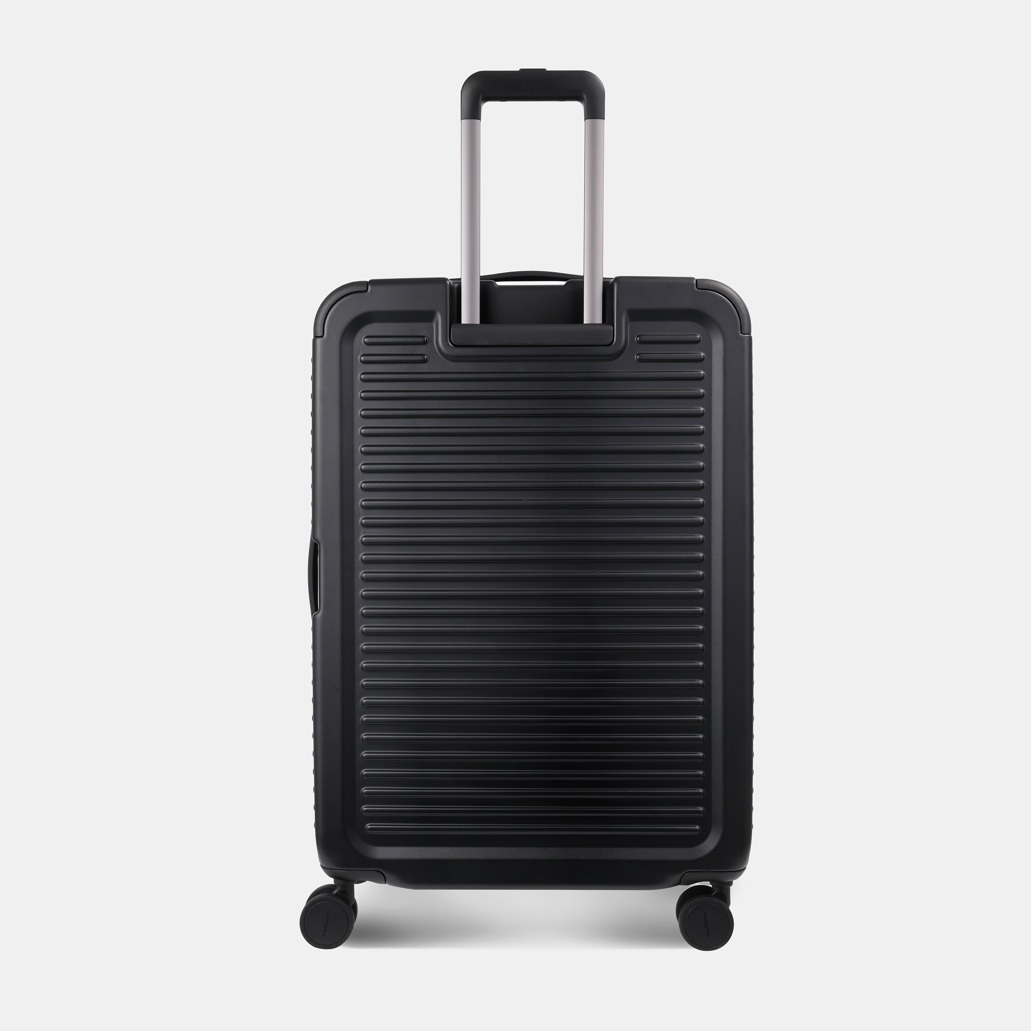 Back view of the Hedgren Raku Yuno luggage in Black, showcasing the textured hard shell and expandable zipper detail. Available for Online Purchase