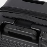 Close-up top view of the Hedgren Raku Yuno hard-shell luggage in Black, showcasing the expandable and carry handles. Shop the Latest Online
